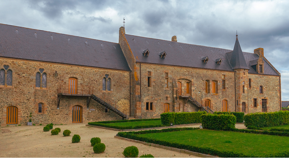 Salle à manger rustique avec cheminée et tables.