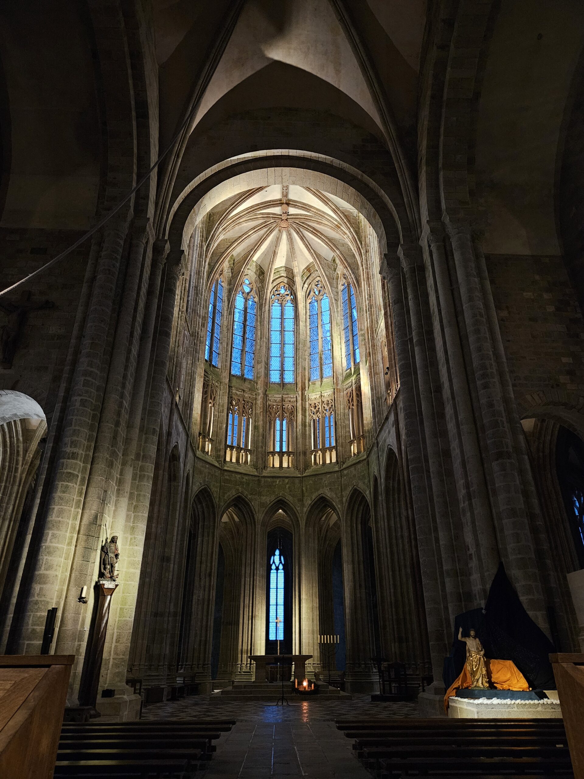 Intérieur d'une église avec vitraux illuminés.