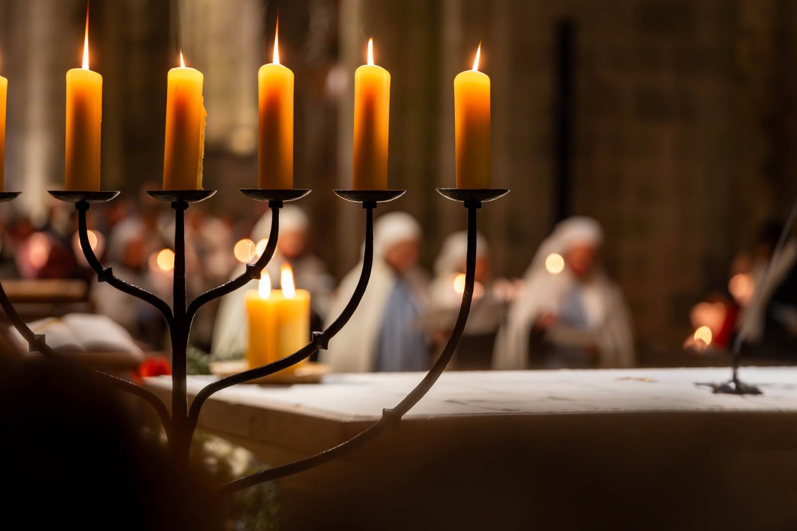 Bougies allumées dans l'église en arrière-plan flou.